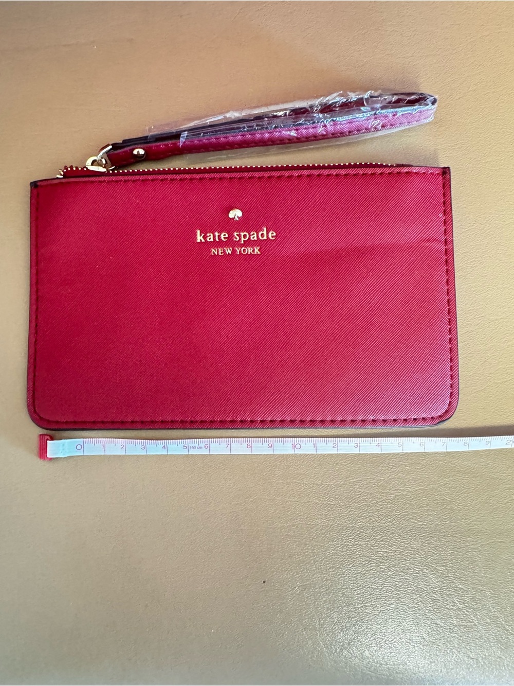 kate spade red zip wristlet with gold logo